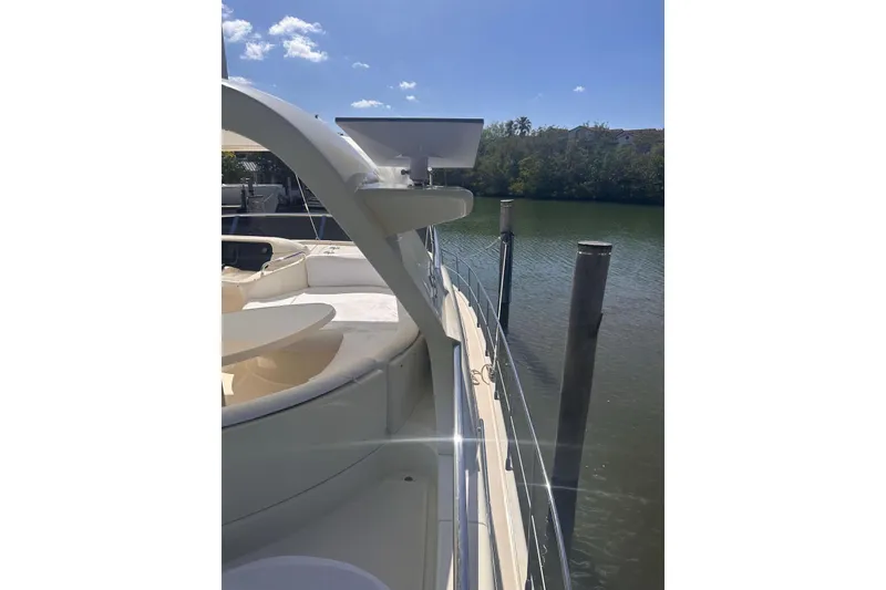 Slide: The Image of 2007 Azimut 55E yacht docked by calm waters under a clear blue sky. - 26