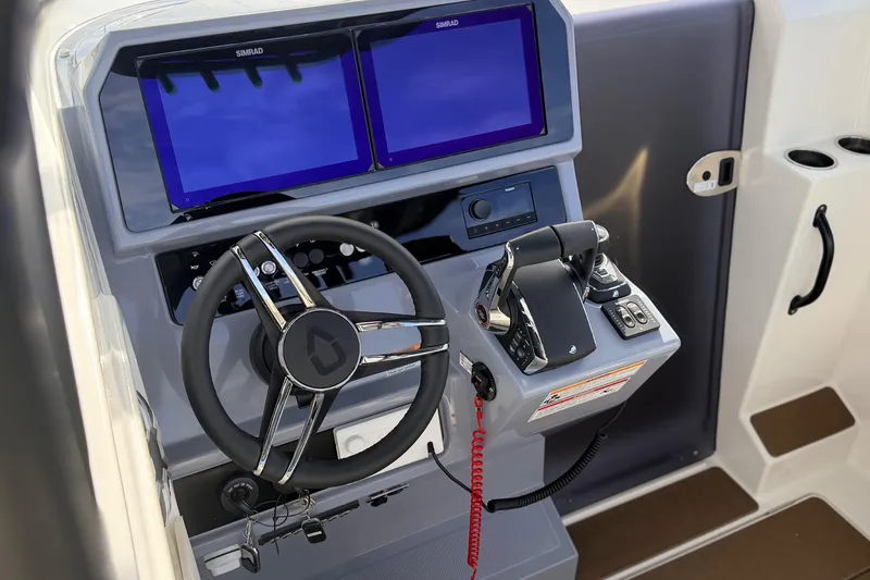 Slide: The Image of Control panel of 2026 Navan S30 boat with dual screens and steering wheel. - 10