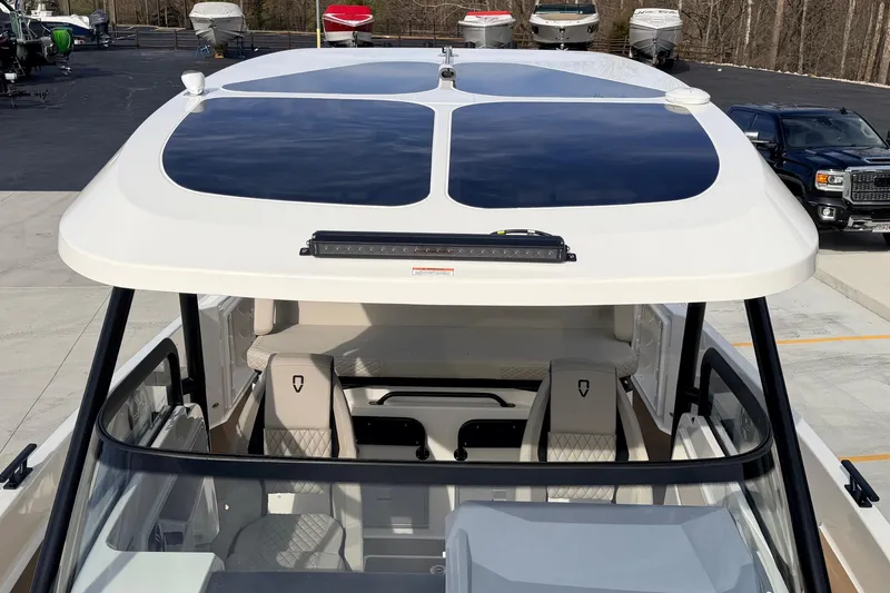 Slide: The Image of Navan S30 2026 boat with sleek design and modern seating, parked outdoors. - 13