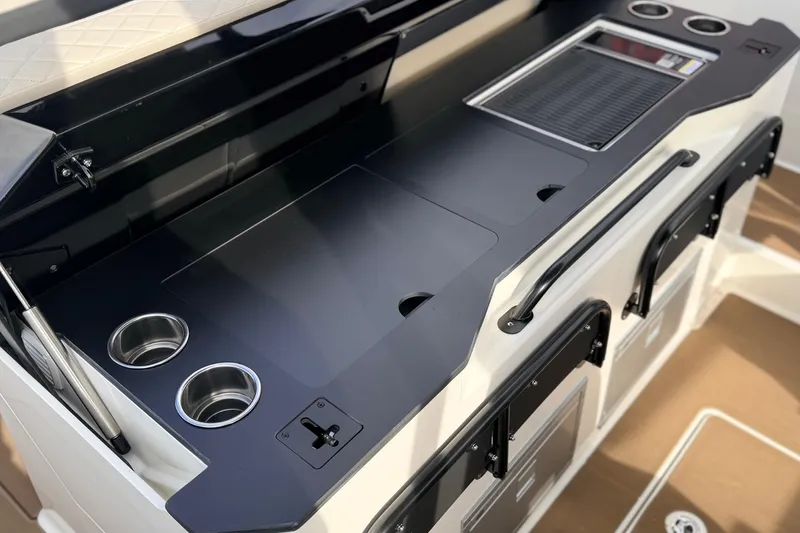 Slide: The Image of 2026 Navan S30 boat interior with sleek black countertop and integrated cup holders. - 19