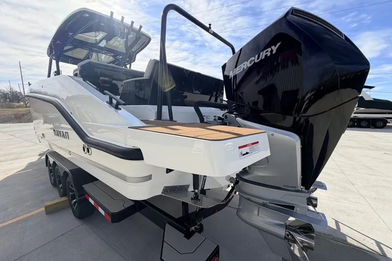 Slide: The Image of 2026 Navan S30 boat with Mercury engine on trailer, outdoor display. - 6