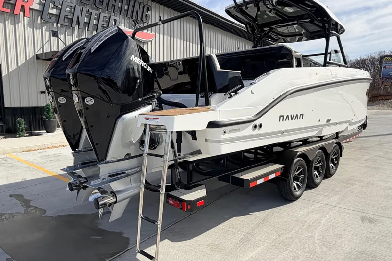 Slide: The Image of 2026 Navan S30 boat with dual Mercury engines on a trailer at a yachting center. - 7