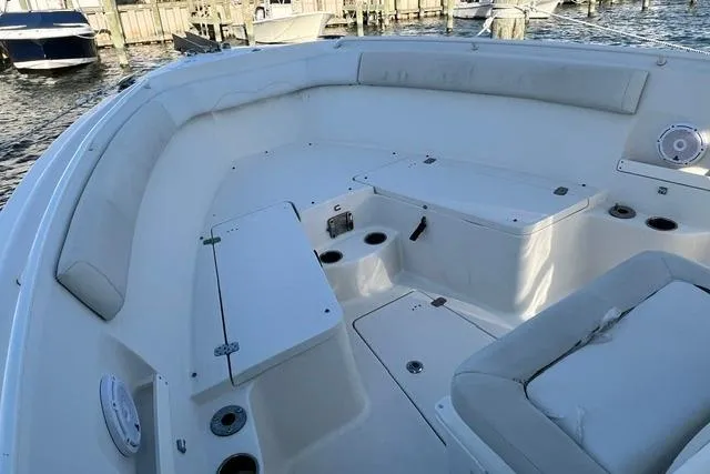 Slide: The Image of 2014 Sailfish 270 CC boat interior with cushioned seating and storage compartments. - 9