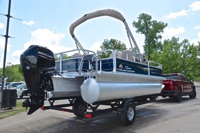 Slide: The Image of 2024 Sun Tracker Bass Buggy 18 DLX pontoon boat on trailer, ready for transport. - 14