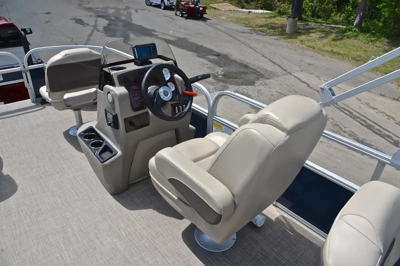 Slide: The Image of 2024 Sun Tracker Bass Buggy 18 DLX boat interior with steering console and seating. - 25