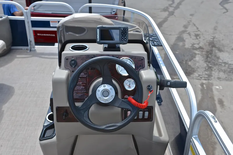 Slide: The Image of 2024 Sun Tracker Bass Buggy 18 DLX steering console with gauges and navigation system. - 26