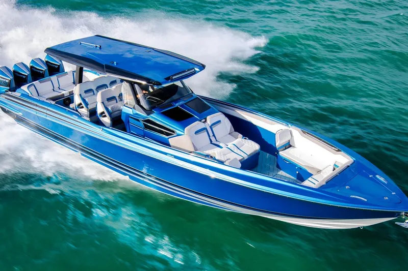 The Image of 2027 Nor-Tech 42 Eleven speedboat cruising on turquoise water, showcasing sleek design and powerful engines. - 0