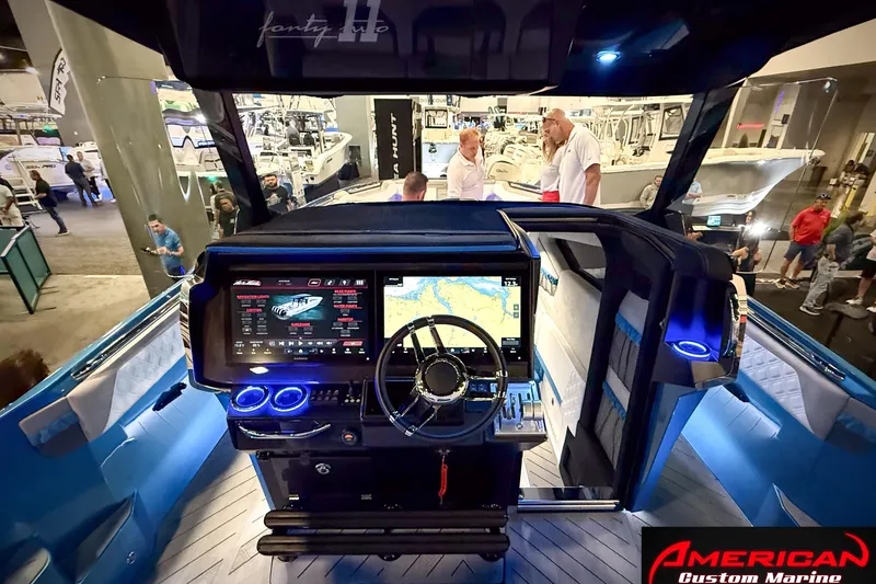 Slide: The Image of Cockpit view of 2027 Nor-Tech 42 Eleven boat at a marine exhibition. - 13