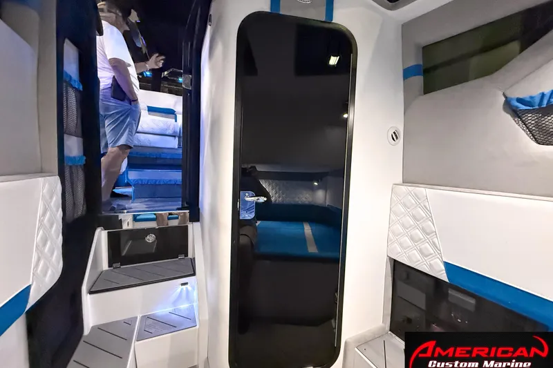 Slide: The Image of Interior of 2027 Nor-Tech 42 Eleven boat with modern design and blue accents. - 16
