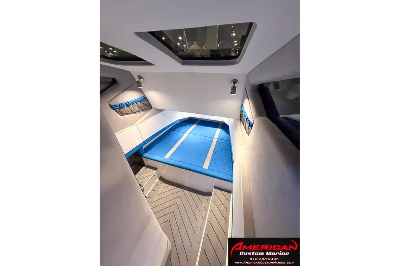 Slide: The Image of Interior cabin of 2027 Nor-Tech 42 Eleven boat with blue bedding and modern design. - 17