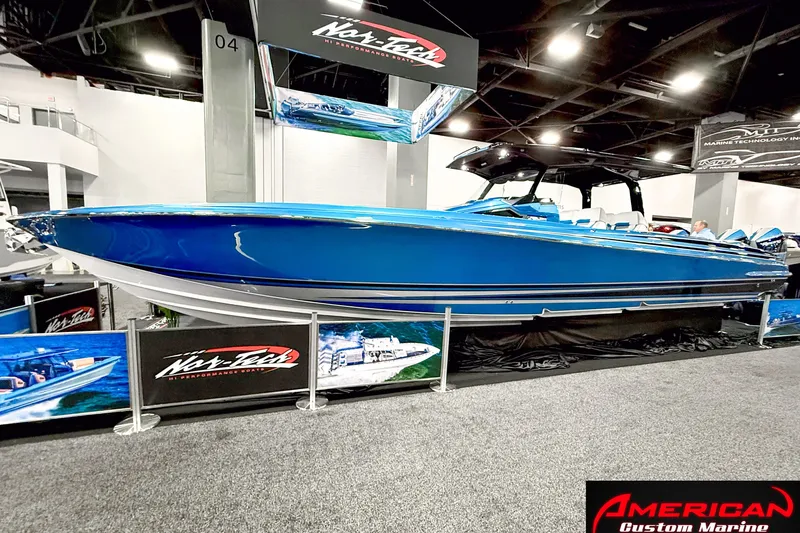 Slide: The Image of 2027 Nor-Tech 42 Eleven boat displayed at an indoor marine exhibition. - 2