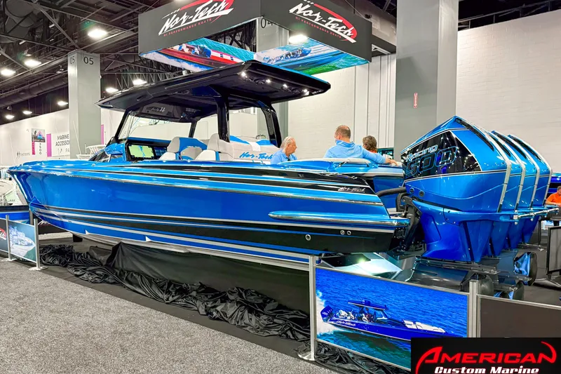 Slide: The Image of 2027 Nor-Tech 42 Eleven boat displayed at a marine exhibition, featuring vibrant blue design. - 3