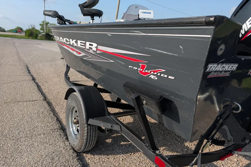 Slide: The Image of 2022 Tracker Pro Guide V-16 SC boat on trailer, parked on roadside. - 75