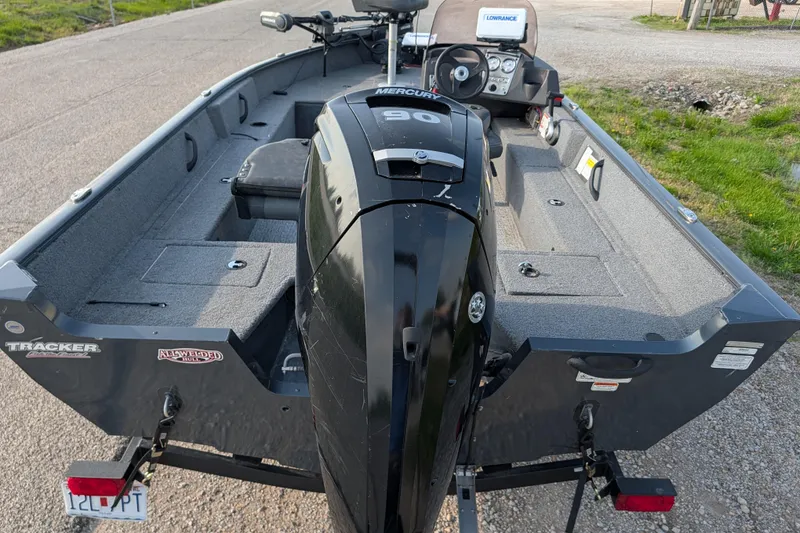 Slide: The Image of 2022 Tracker Pro Guide V-16 SC boat with Mercury 90 engine, parked on a trailer. - 76