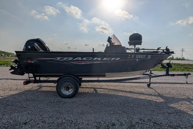 Slide: The Image of 2022 Tracker Pro Guide V-16 SC boat on trailer under sunny sky. - 79