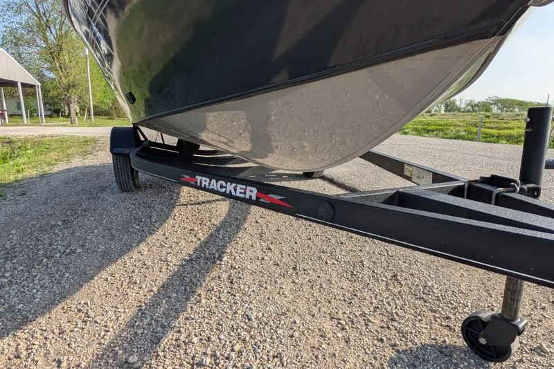 Slide: The Image of 2022 Tracker Pro Guide V-16 SC boat on trailer, parked on gravel road. - 81