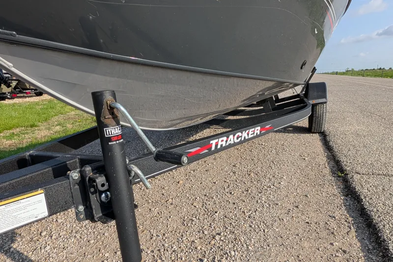 Slide: The Image of 2022 Tracker Pro Guide V-16 SC boat on trailer, parked on a paved road. - 82