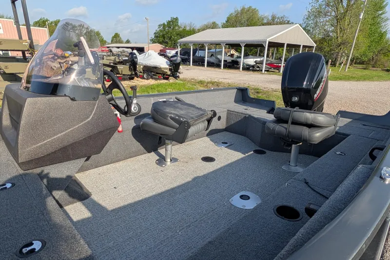 Slide: The Image of 2022 Tracker Pro Guide V-16 SC boat interior with seating and steering console. - 85