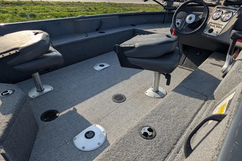 Slide: The Image of 2022 Tracker Pro Guide V-16 SC boat interior with seating and steering console. - 89