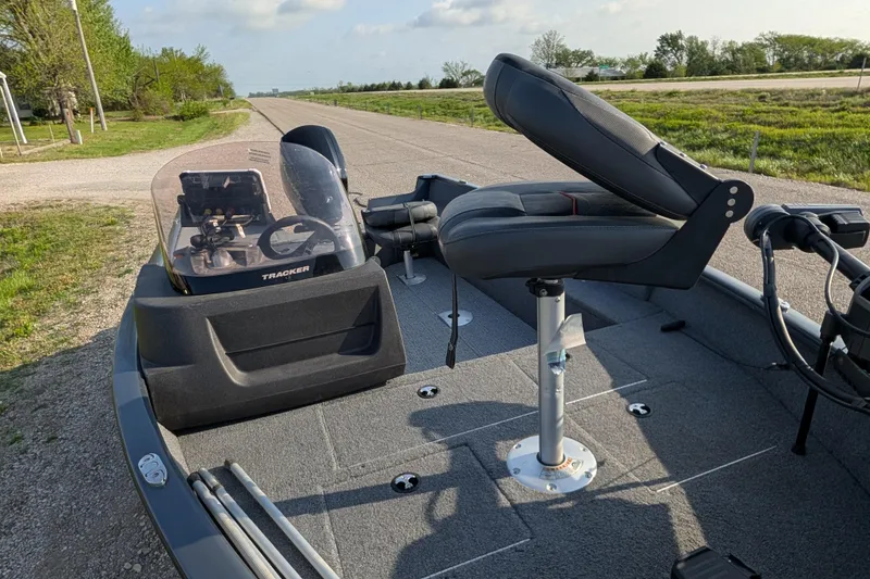 Slide: The Image of 2022 Tracker Pro Guide V-16 SC boat interior with seating and steering console. - 90