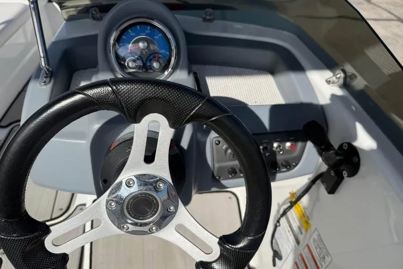 Slide: The Image of Steering wheel and dashboard of a 2020 Tahoe T16 boat, featuring gauges and controls. - 11