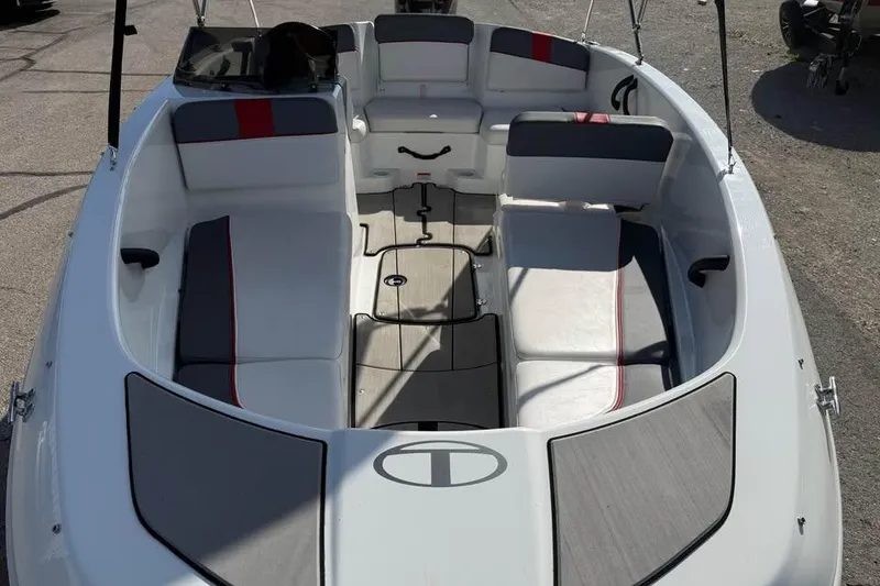 Slide: The Image of 2020 Tahoe T16 boat interior with gray and red seating, open deck layout. - 13