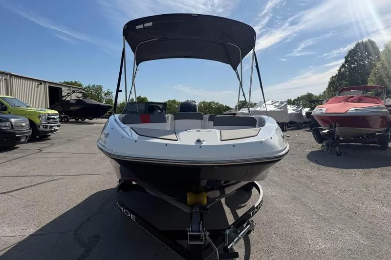Slide: The Image of 2020 Tahoe T16 boat with canopy on trailer in sunny outdoor setting. - 2