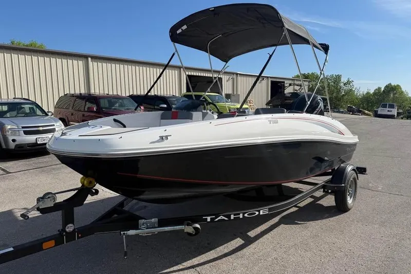 Slide: The Image of 2020 Tahoe T16 boat on trailer, parked outdoors under clear sky. - 3