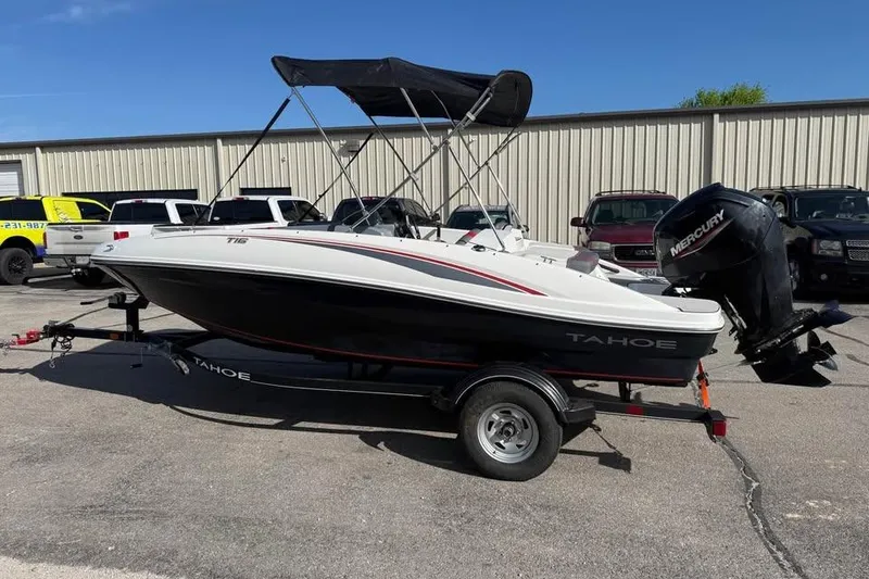 Slide: The Image of 2020 Tahoe T16 boat with Mercury engine on trailer, parked outdoors. - 4