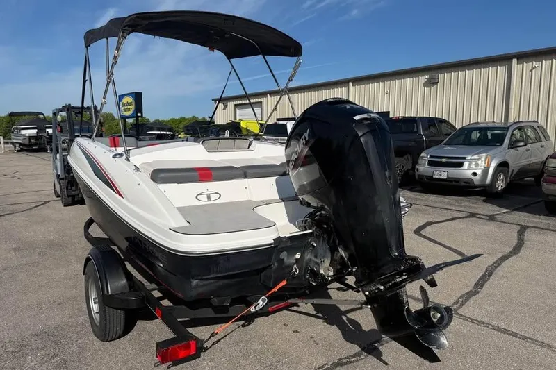 Slide: The Image of 2020 Tahoe T16 boat with outboard motor on trailer in parking lot. - 5