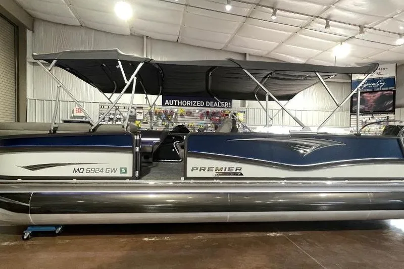 The Image of 2024 Premier 270 Intrigue pontoon boat displayed indoors at an authorized dealer showroom. - 0