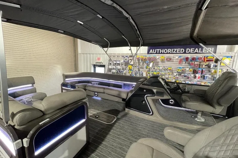 Slide: The Image of Luxurious interior of 2024 Premier 270 Intrigue pontoon boat with plush seating and modern dashboard. - 11