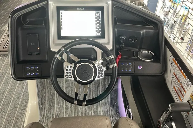 Slide: The Image of 2024 Premier 270 Intrigue boat dashboard with steering wheel and digital display. - 13