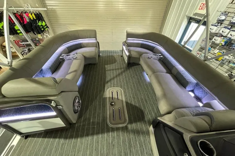 Slide: The Image of Luxurious interior of 2024 Premier 270 Intrigue pontoon boat with plush seating and ambient lighting. - 16