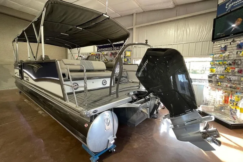 Slide: The Image of 2024 Premier 270 Intrigue pontoon boat with Mercury outboard motor in showroom. - 3