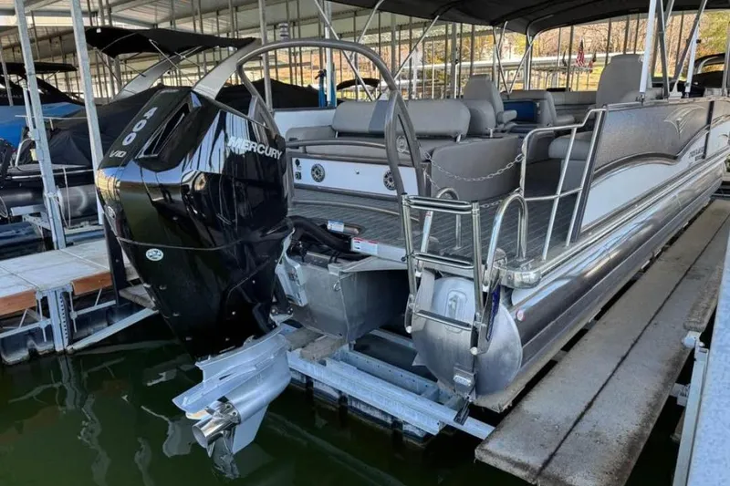 Slide: The Image of 2024 Premier 270 Intrigue pontoon boat with Mercury 400 engine docked in marina. - 5