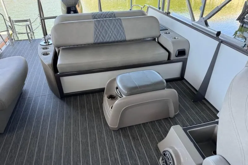 Slide: The Image of Interior of 2024 Premier 270 Intrigue boat with gray seating and cup holders. - 7