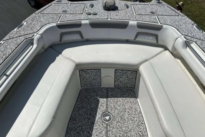 Slide: The Image of 2018 World Cat 320 CC boat interior with cushioned seating and textured flooring. - 13
