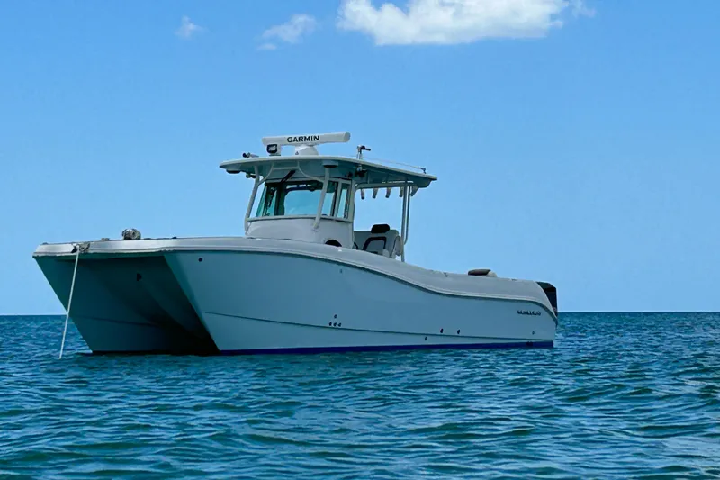 Slide: The Image of 2018 World Cat 320 CC boat floating on calm blue ocean waters. - 2