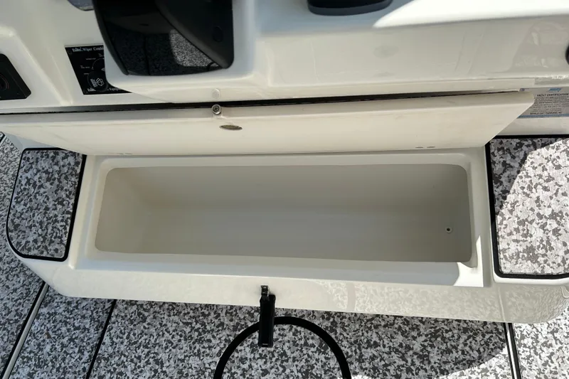 Slide: The Image of Open storage compartment on 2018 World Cat 320 CC boat, featuring textured flooring. - 22