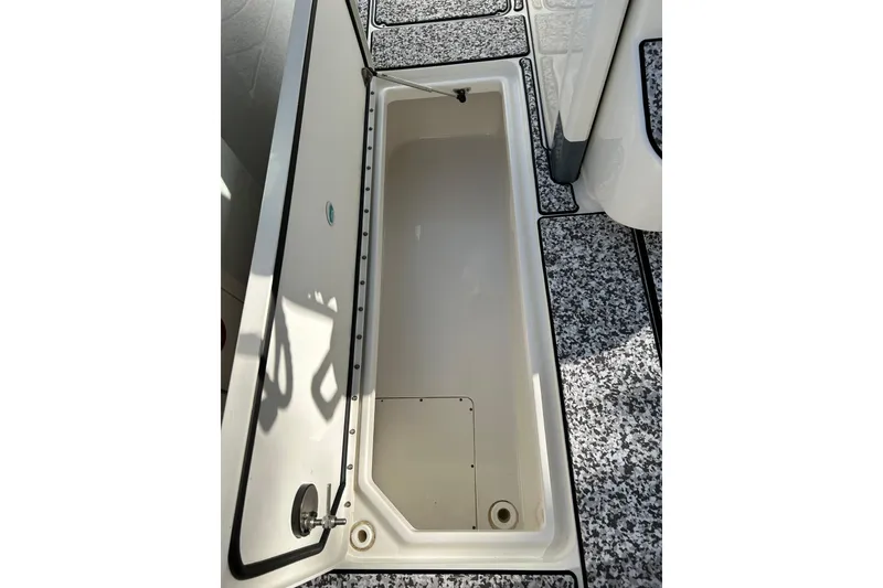 Slide: The Image of Open storage compartment on 2018 World Cat 320 CC boat deck. - 23