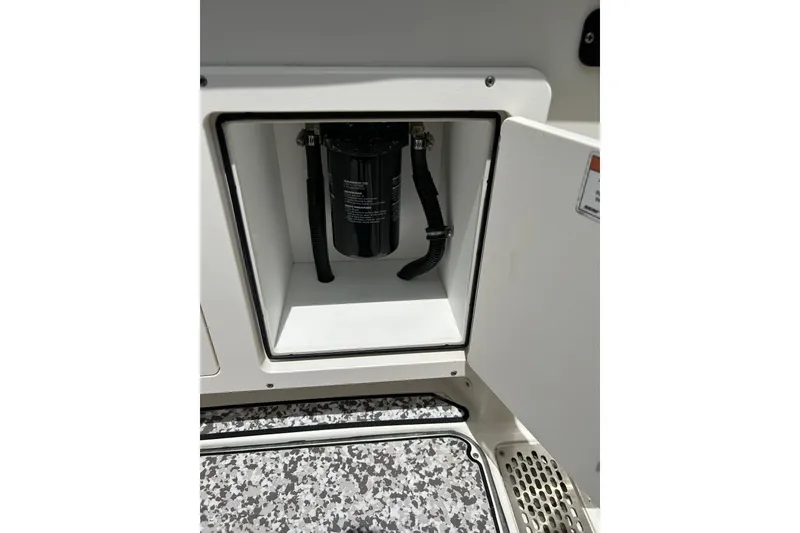 Slide: The Image of Open compartment on 2018 World Cat 320 CC boat showing internal components. - 28