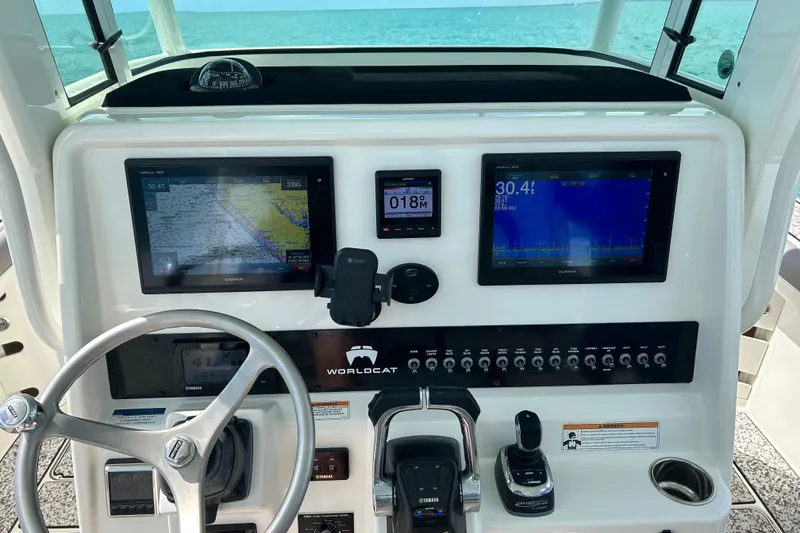 Slide: The Image of Helm of 2018 World Cat 320 CC with navigation screens and controls. - 5