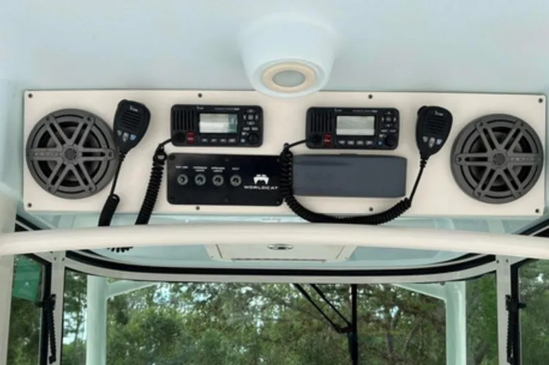 Slide: The Image of 2018 World Cat 320 CC boat dashboard with speakers and communication devices. - 6