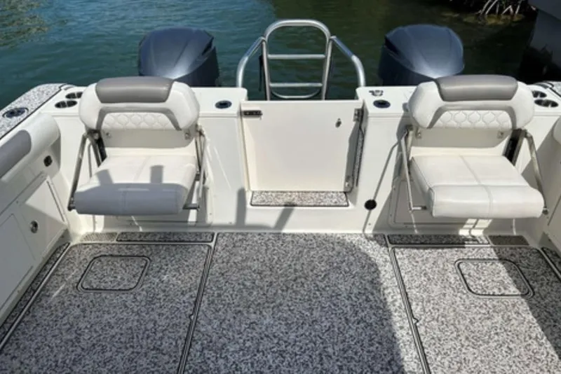Slide: The Image of 2018 World Cat 320 CC boat interior with seating and twin engines. - 7