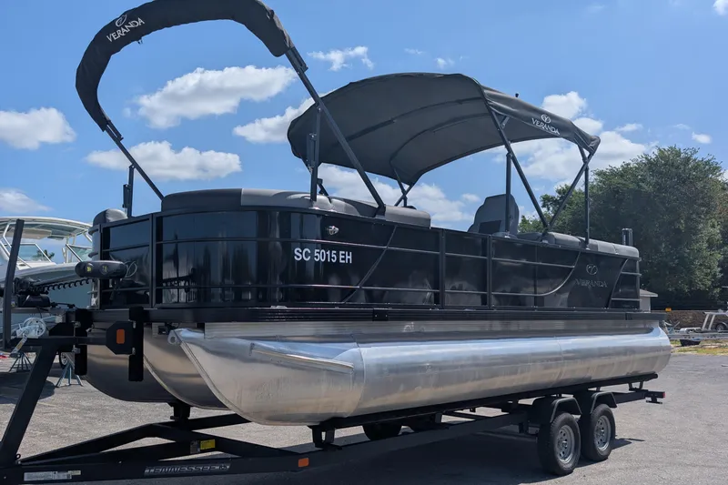 The Image of 2025 Veranda Relax VR 22 RC pontoon boat on trailer under blue sky. - 0