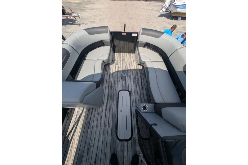 Slide: The Image of 2025 Veranda Relax VR 22 RC pontoon boat interior with gray seating and wooden deck. - 11