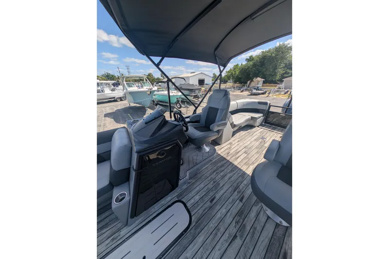 Slide: The Image of 2025 Veranda Relax VR 22 RC pontoon boat interior with helm and seating. - 3
