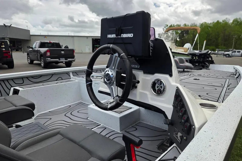 Slide: The Image of 2021 Xpress X21 Pro boat interior with steering wheel and Humminbird electronics. - 10
