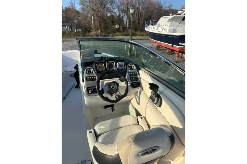 Slide: The Image of 2012 Chaparral 267 SSX boat cockpit with steering wheel and control panel. - 2